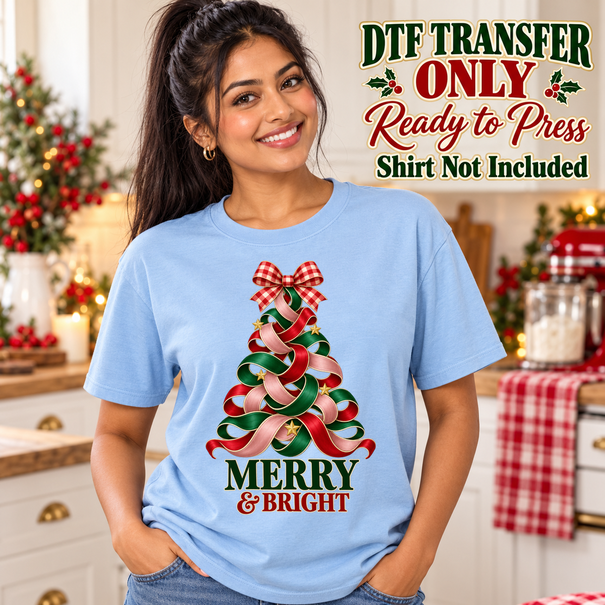 Woman in a light blue tee with a red and green ribbon Christmas tree, gingham bow and Merry and Bright wording, labeled transfer only.