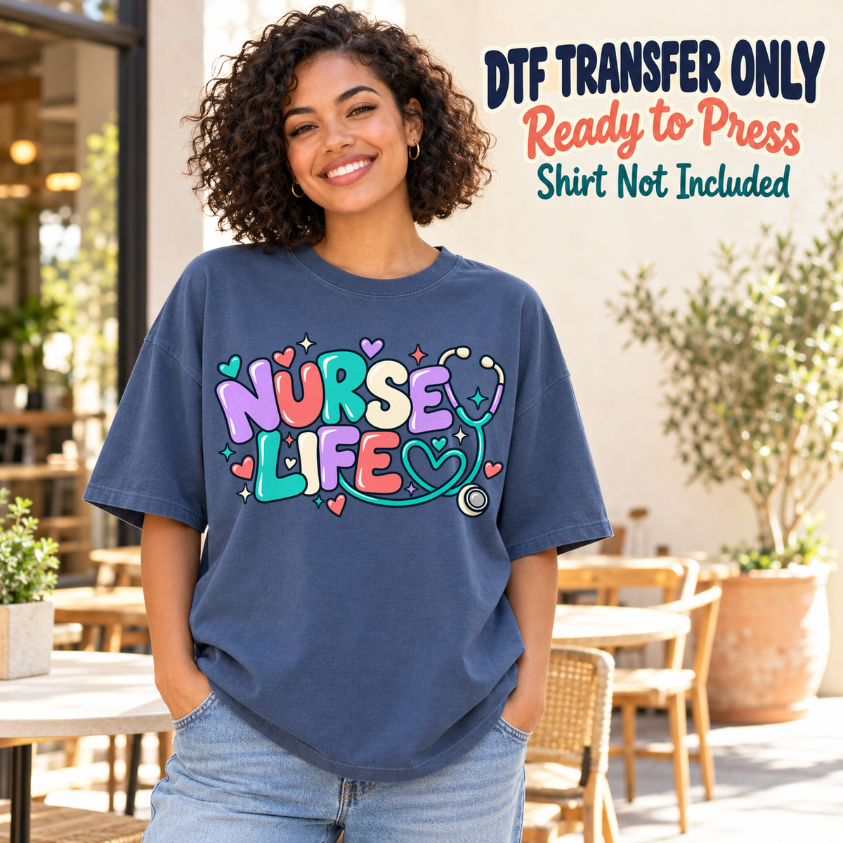Woman wearing a navy tee with colorful Nurse Life bubble lettering, hearts and a stethoscope, labeled DTF transfer only.