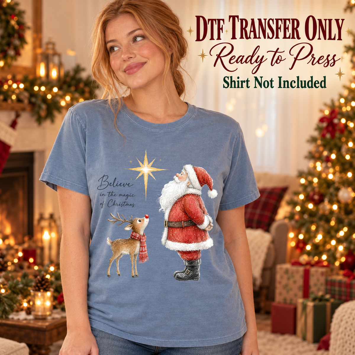 Woman in a blue tee with Santa and a small reindeer looking toward a star, plus Believe in the Magic of Christmas text, labeled transfer only.