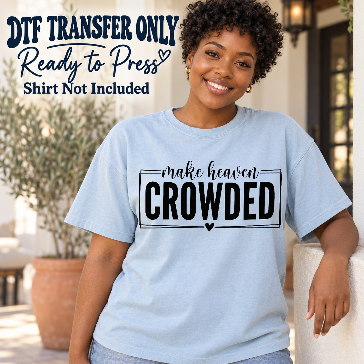 Woman in a light blue tee with Make Heaven Crowded lettering, a rectangular frame around Crowded and a heart below, labeled transfer only.
