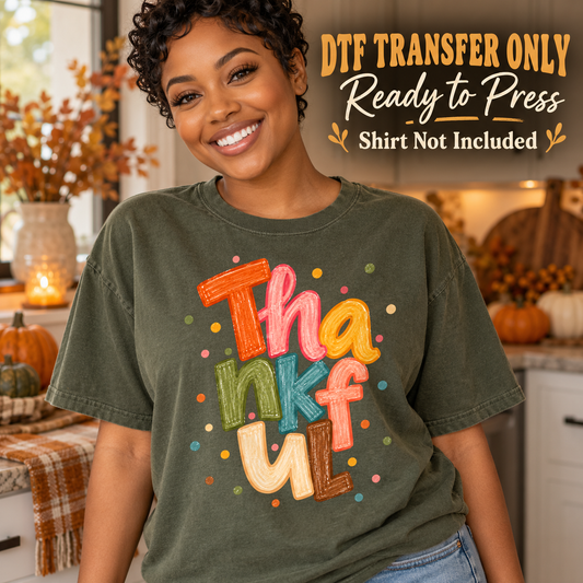 Woman in an olive green tee with colorful stacked Thankful lettering and small decorative dots, labeled DTF transfer only.