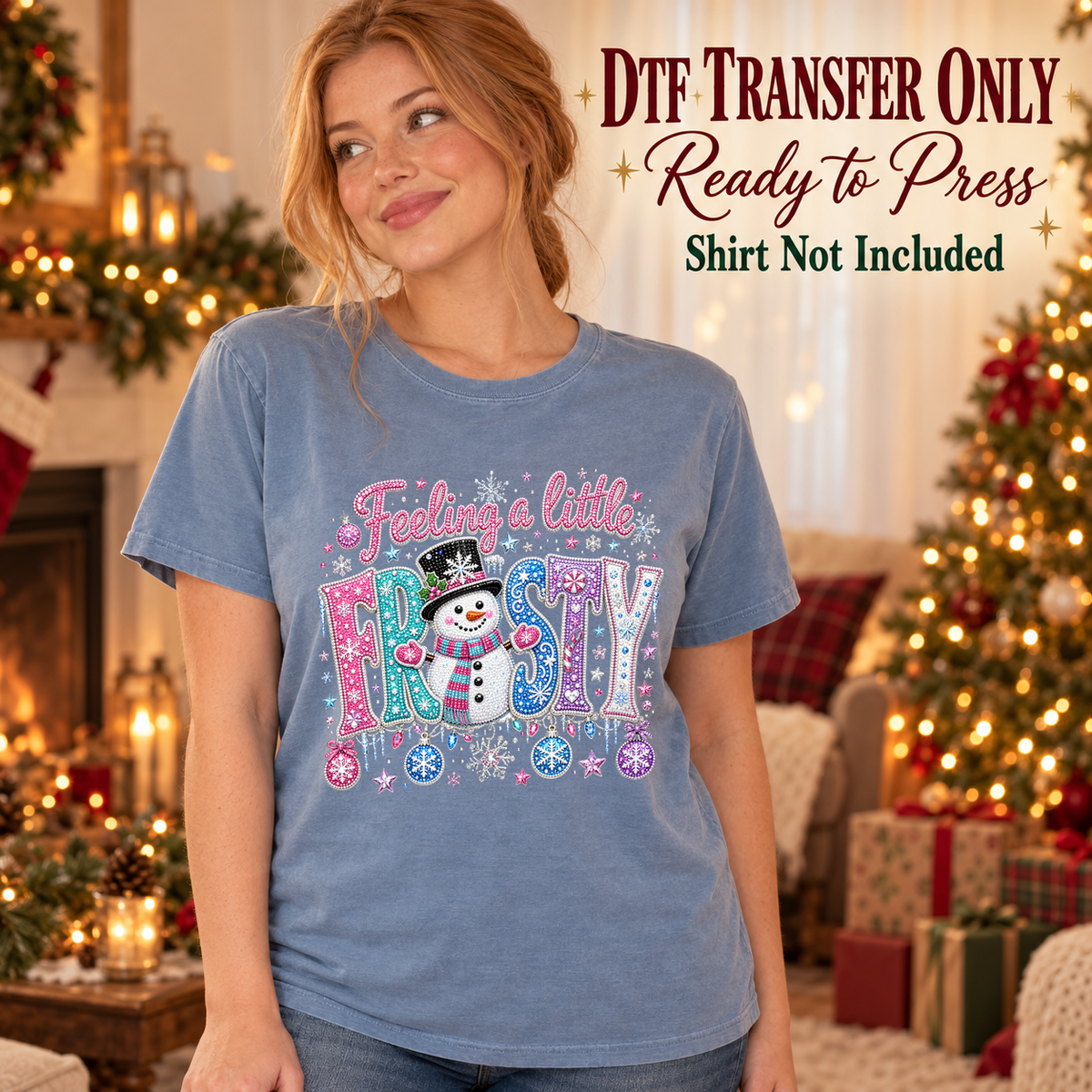 Woman in a blue tee with pink and blue Feelin a Little Frosty lettering, a snowman and snowflakes, labeled DTF transfer only.