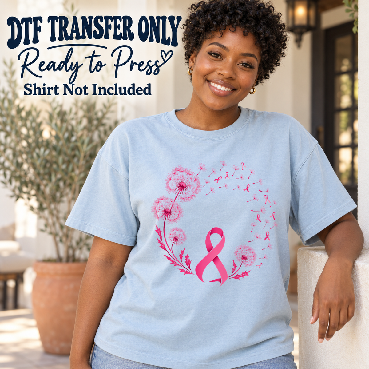 Woman in a light blue tee with a pink awareness ribbon inside an open circle of dandelions and floating ribbon seeds, labeled transfer only.