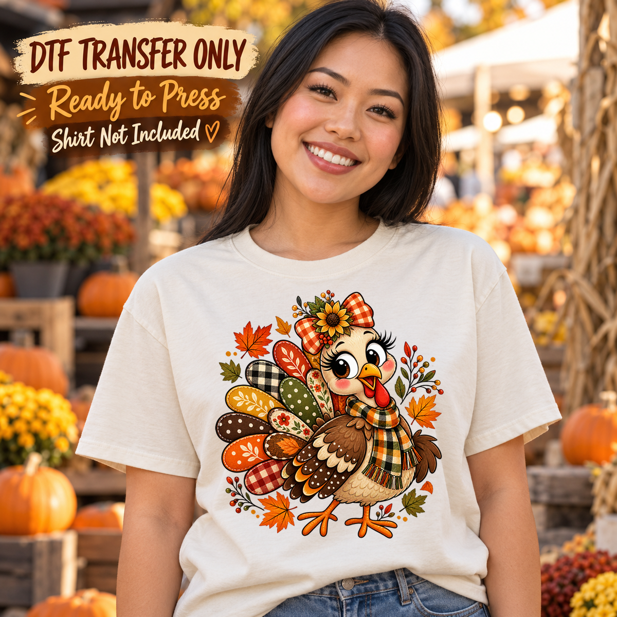 Woman in an ivory tee showing a cute turkey with a plaid bow, patterned tail feathers and autumn leaves, labeled DTF transfer only.