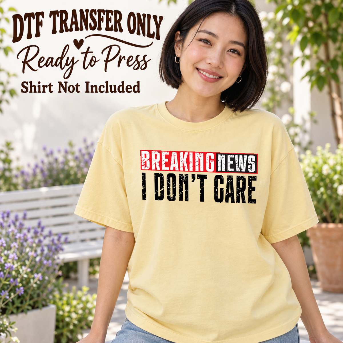 Woman in a pale yellow tee with red and black Breaking News I Don't Care headline-style lettering, labeled DTF transfer only.