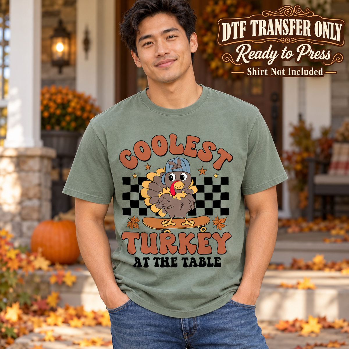 Man in a sage green tee with a blue-cap turkey, black checkerboard and Coolest Turkey at the Table text, labeled transfer only.