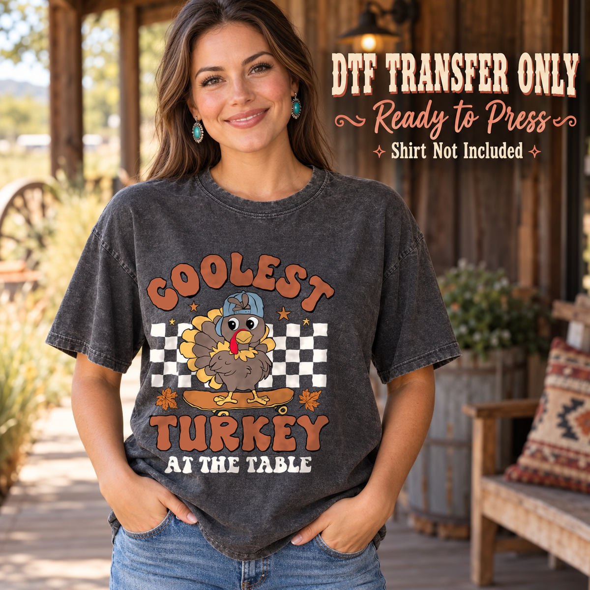 Woman in a charcoal washed tee with a blue-cap turkey, white checkerboard and Coolest Turkey at the Table lettering, labeled transfer only.