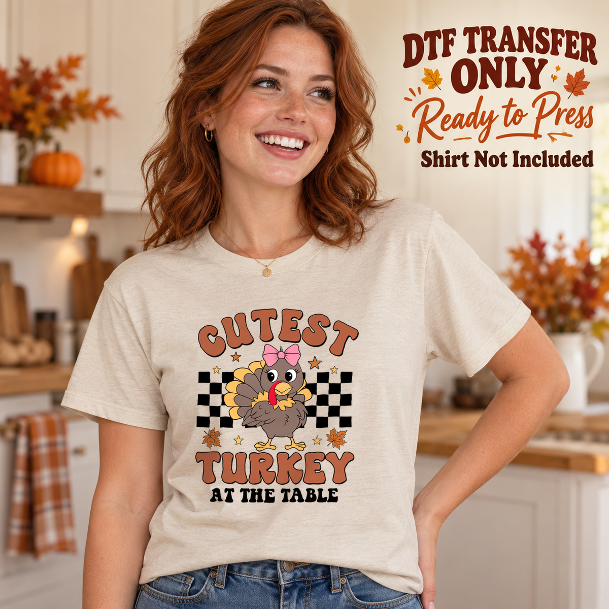Woman in an ivory tee with a pink-bow turkey, black checkerboard and Cutest Turkey at the Table wording, labeled DTF transfer only.