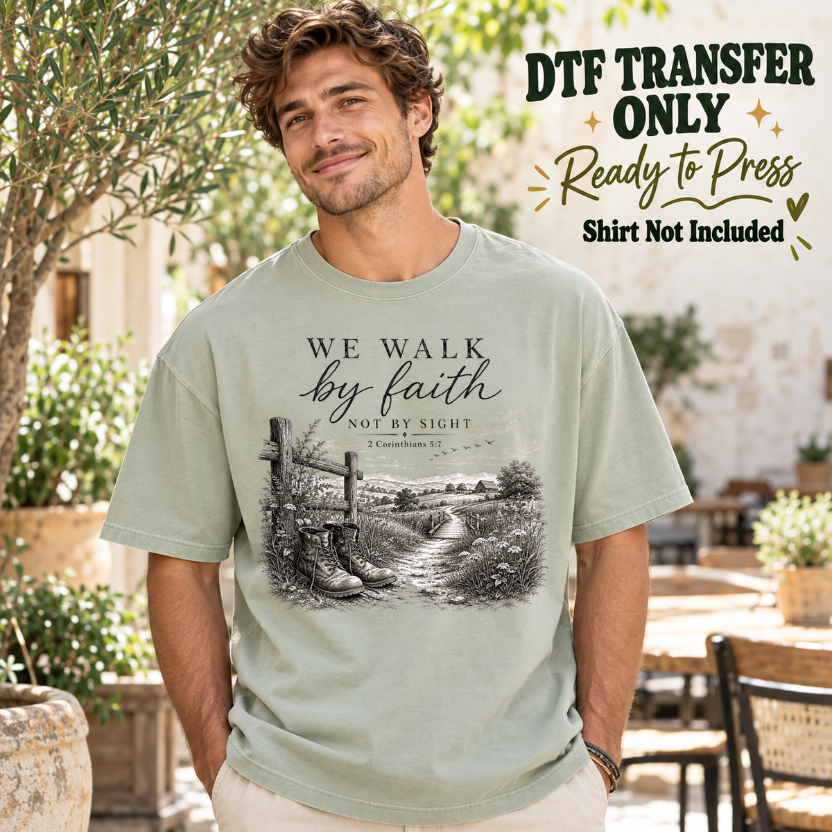 Man in a sage green tee with We Walk by Faith Not by Sight text above boots, a fence and a country path, labeled transfer only.