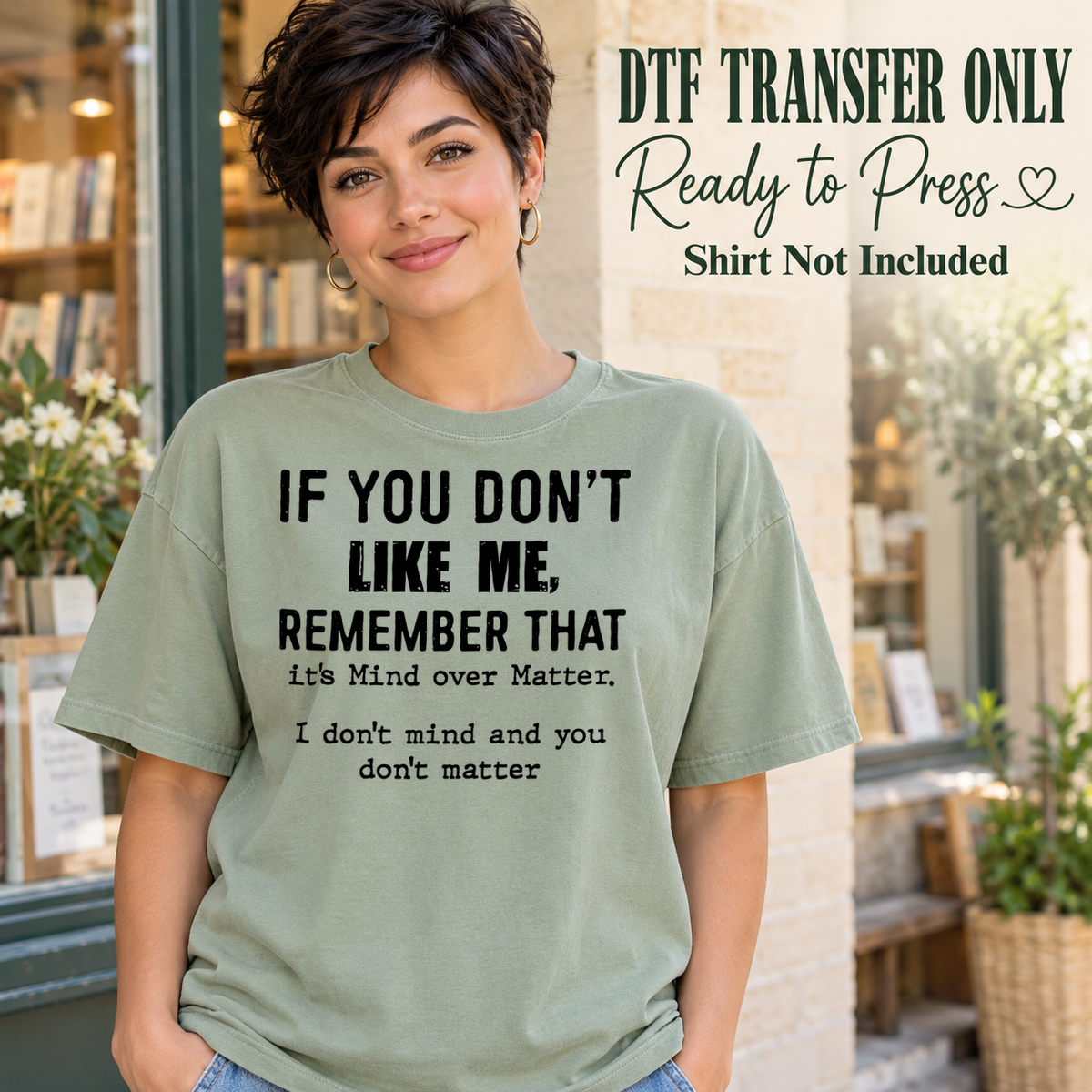 Woman in a sage green tee with black If You Don't Like Me, Mind Over Matter and I Don't Mind and You Don't Matter wording, labeled transfer only.