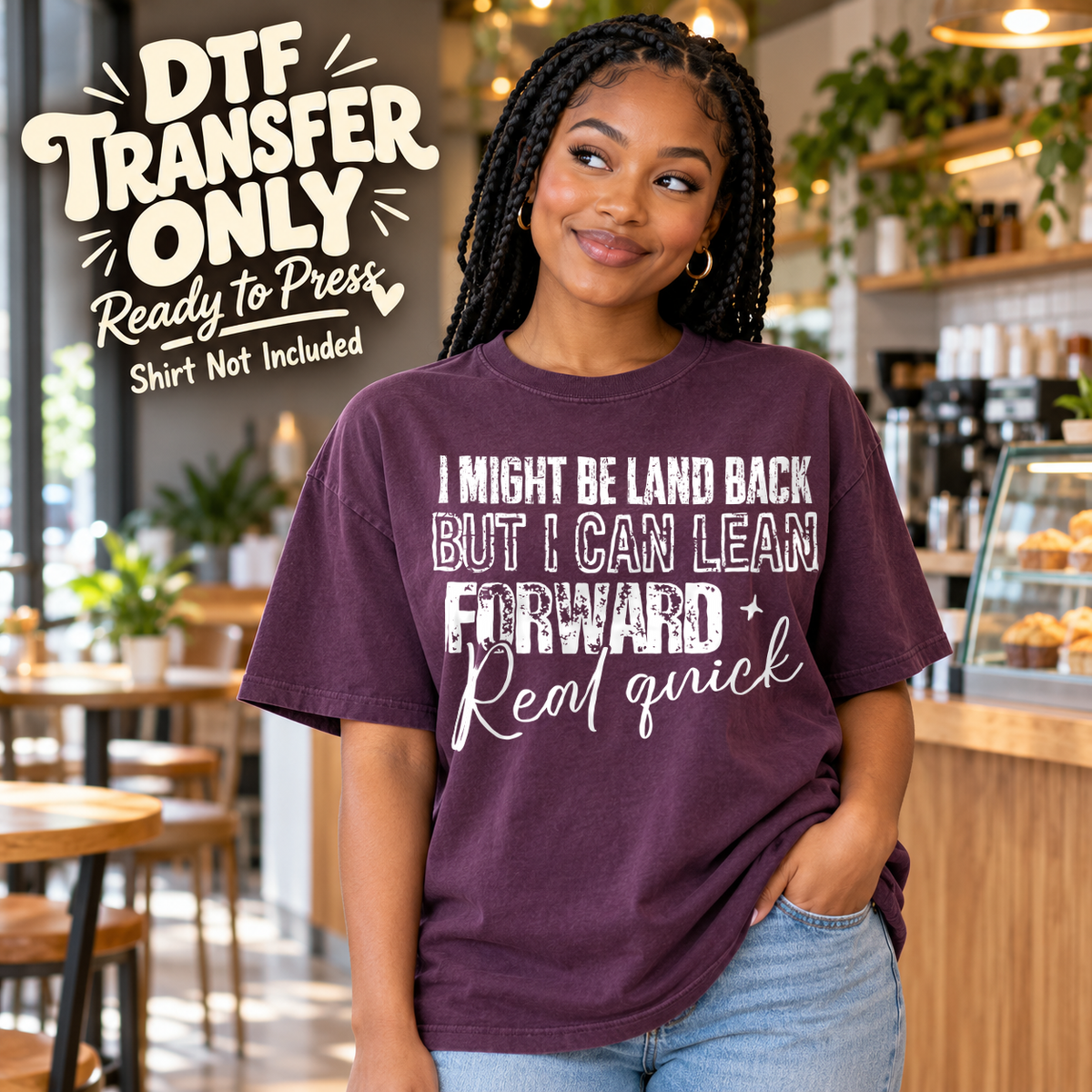 Woman in a plum tee with white I Might Be Laid Back But I Can Lean Forward Real Quick lettering, labeled DTF transfer only.