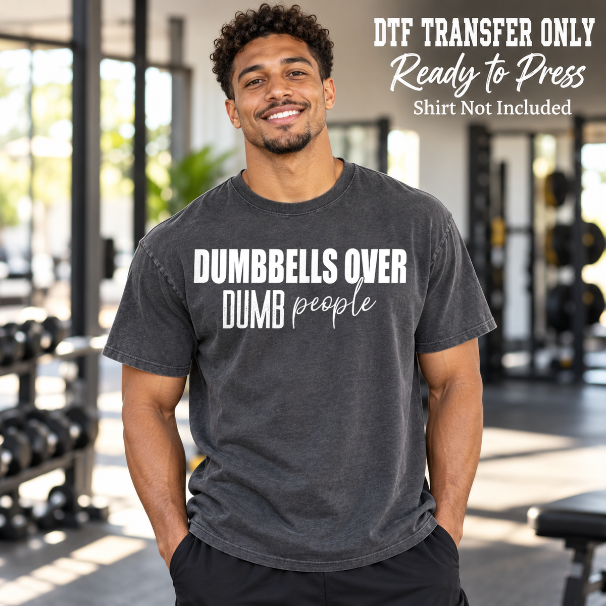 Man in a charcoal washed tee with white Dumbbells Over Dumb People text in block and script lettering, labeled transfer only.