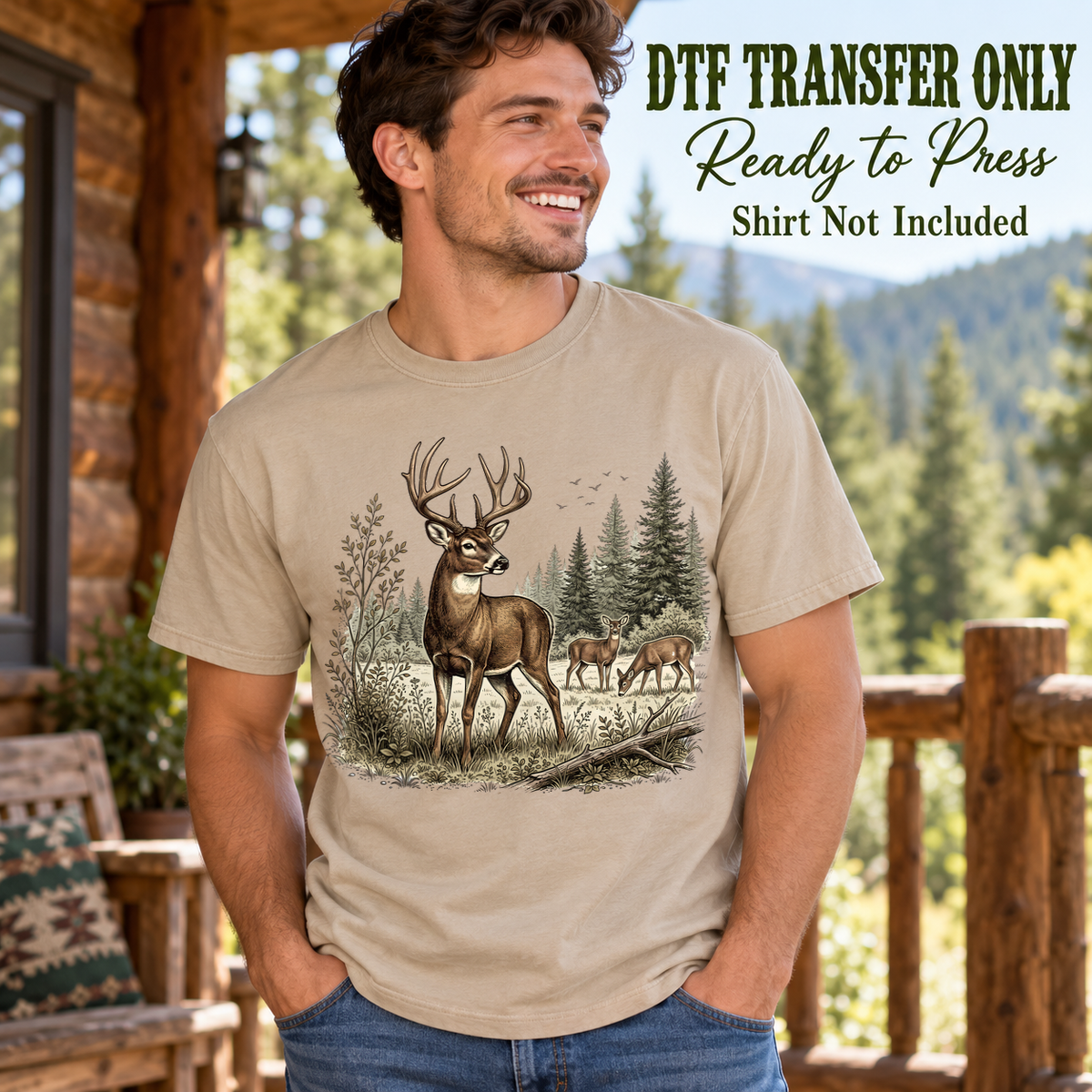 Man in a tan tee displaying an illustrated buck with grazing deer, evergreen trees and woodland plants, labeled DTF transfer only.