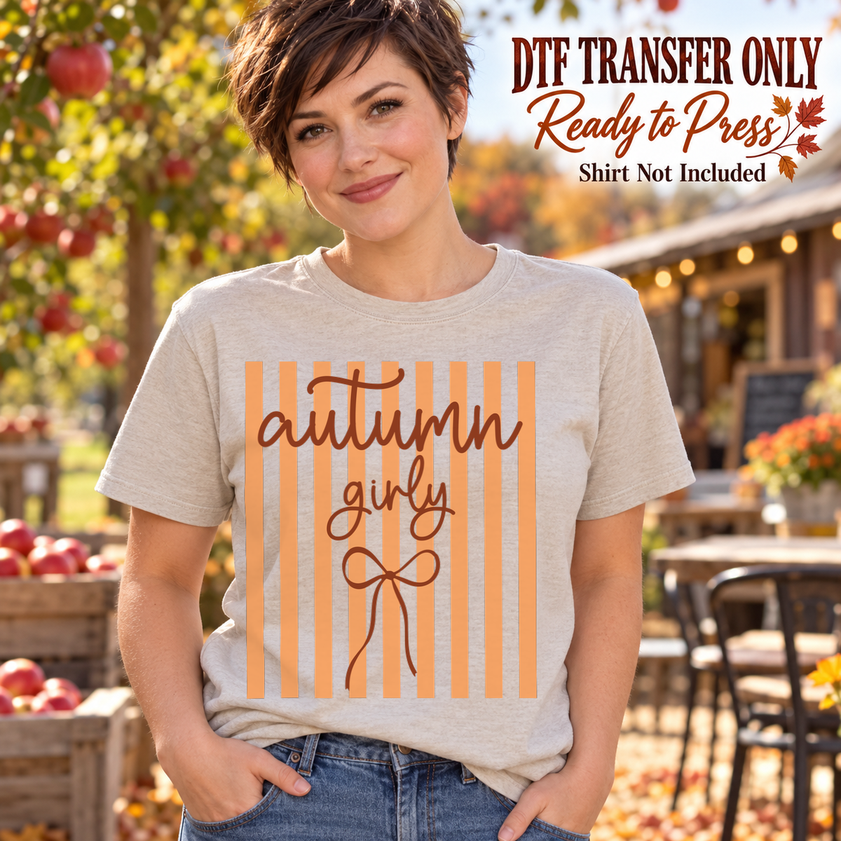Woman in a light gray tee with orange vertical stripes, brown Autumn Girly script and a line-drawn bow, labeled DTF transfer only.