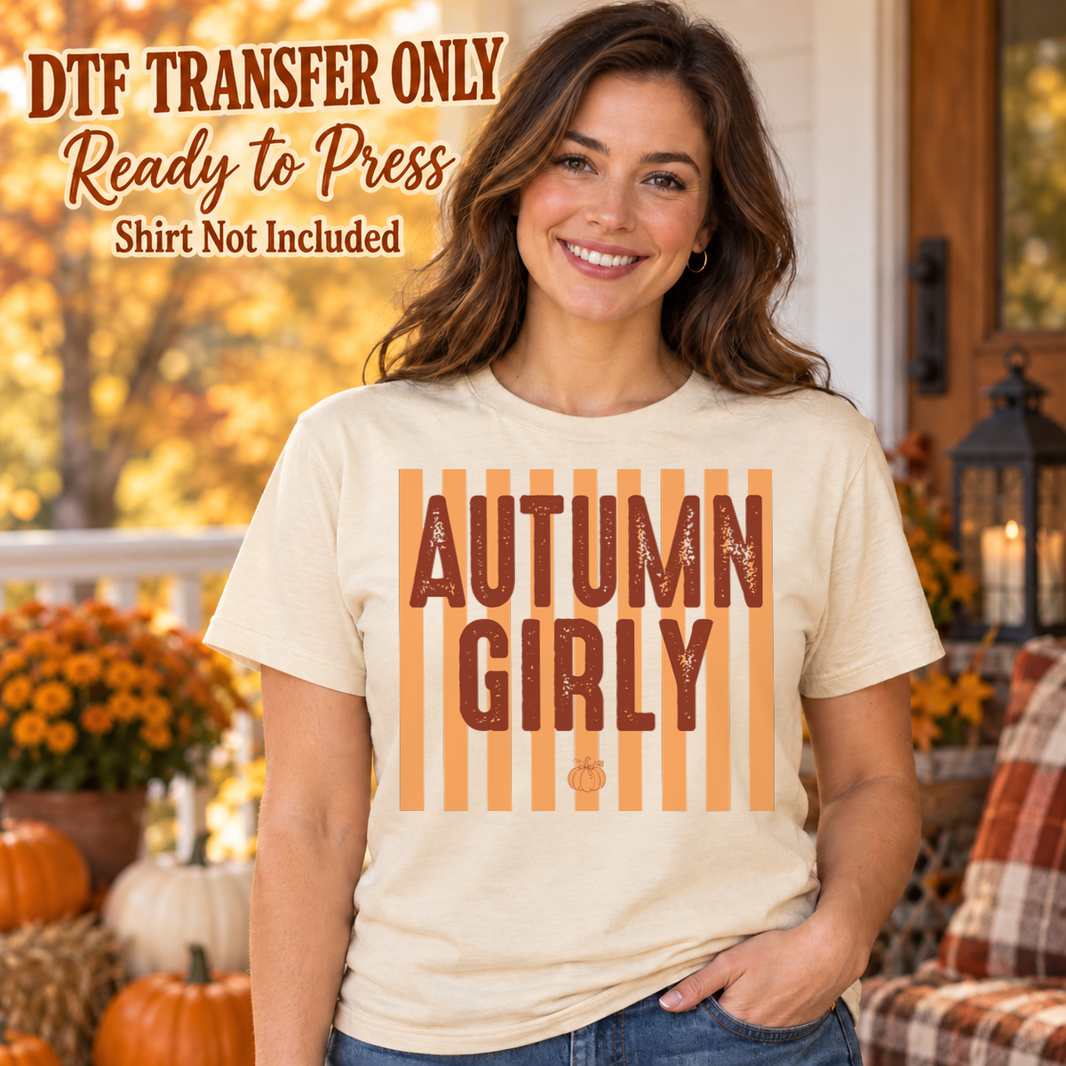 Woman in an ivory tee with Autumn Girly block lettering over orange vertical stripes and a small pumpkin, labeled DTF transfer only.