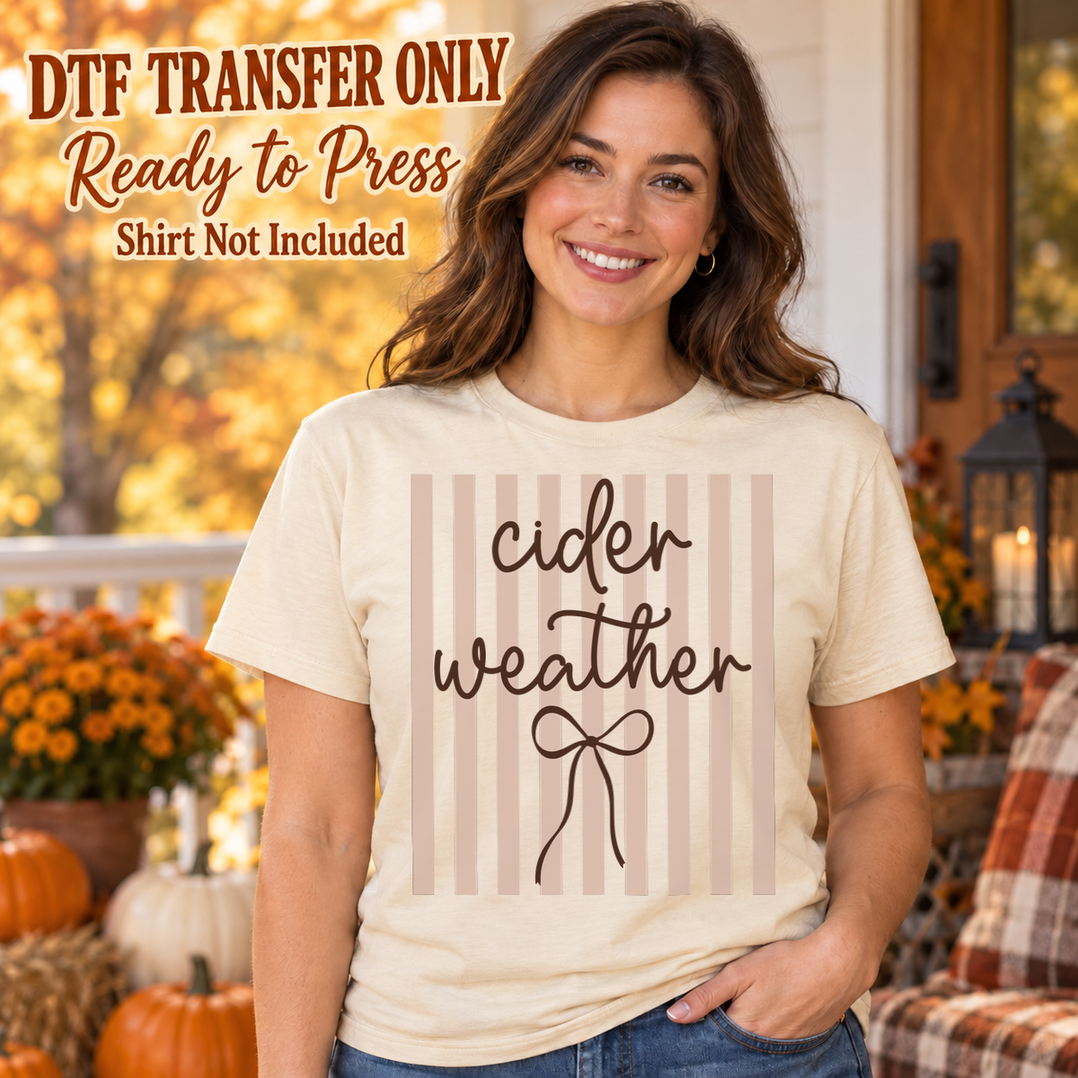 Woman in an ivory tee with muted pink vertical stripes, brown Cider Weather script and a line-drawn bow, labeled transfer only.