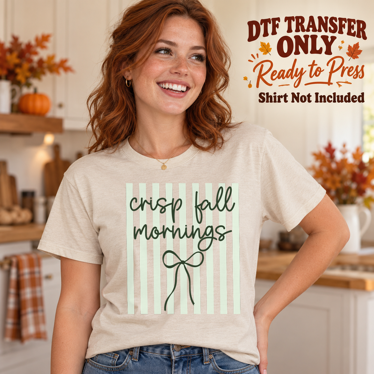 Woman in an ivory tee with pale sage vertical stripes, green Crisp Fall Mornings script and a line-drawn bow, labeled transfer only.