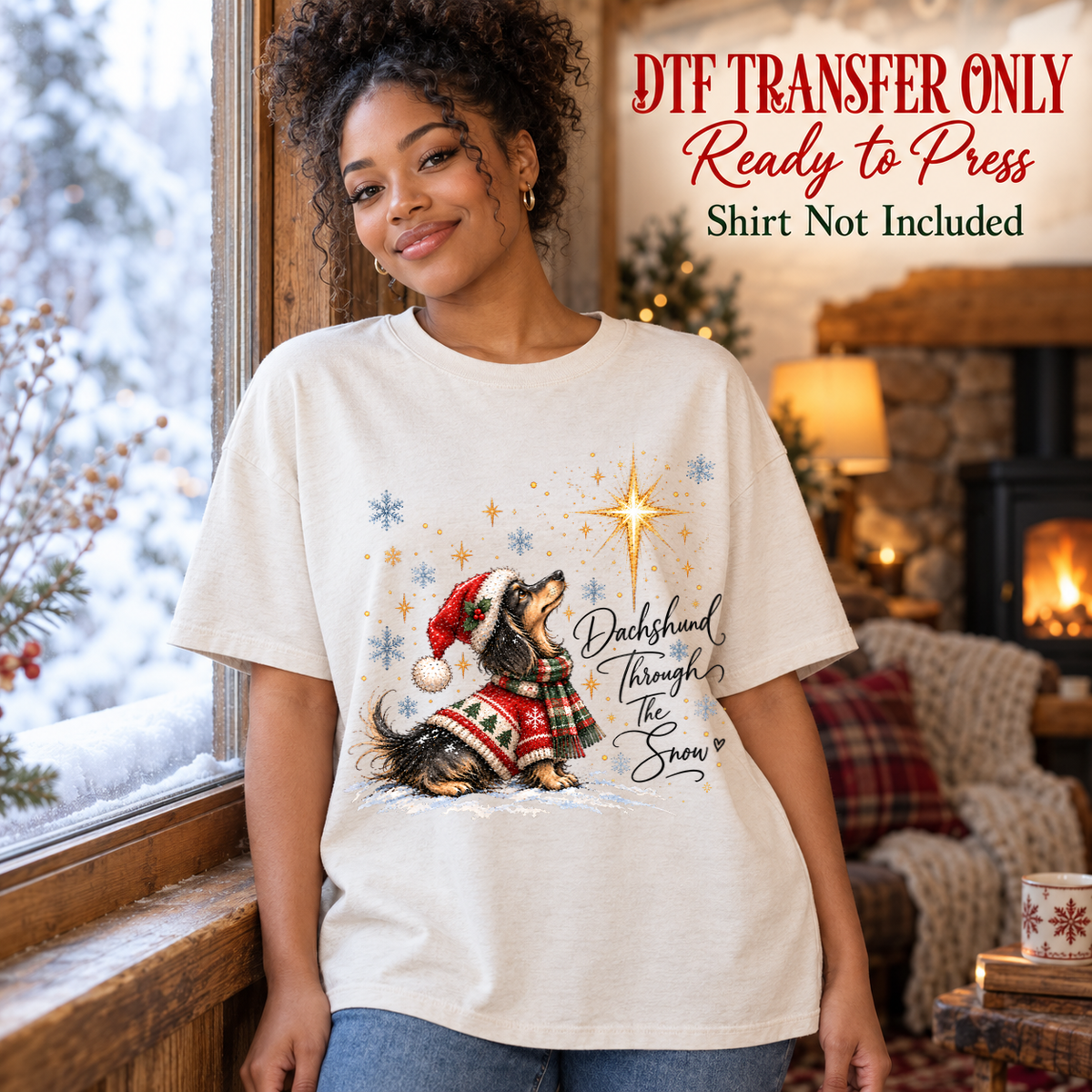 Dachshund in a Santa hat and patterned sweater beside Dachshund Through the Snow lettering, shown on a white shirt model mockup; physical DTF transfer only, shirt not included.