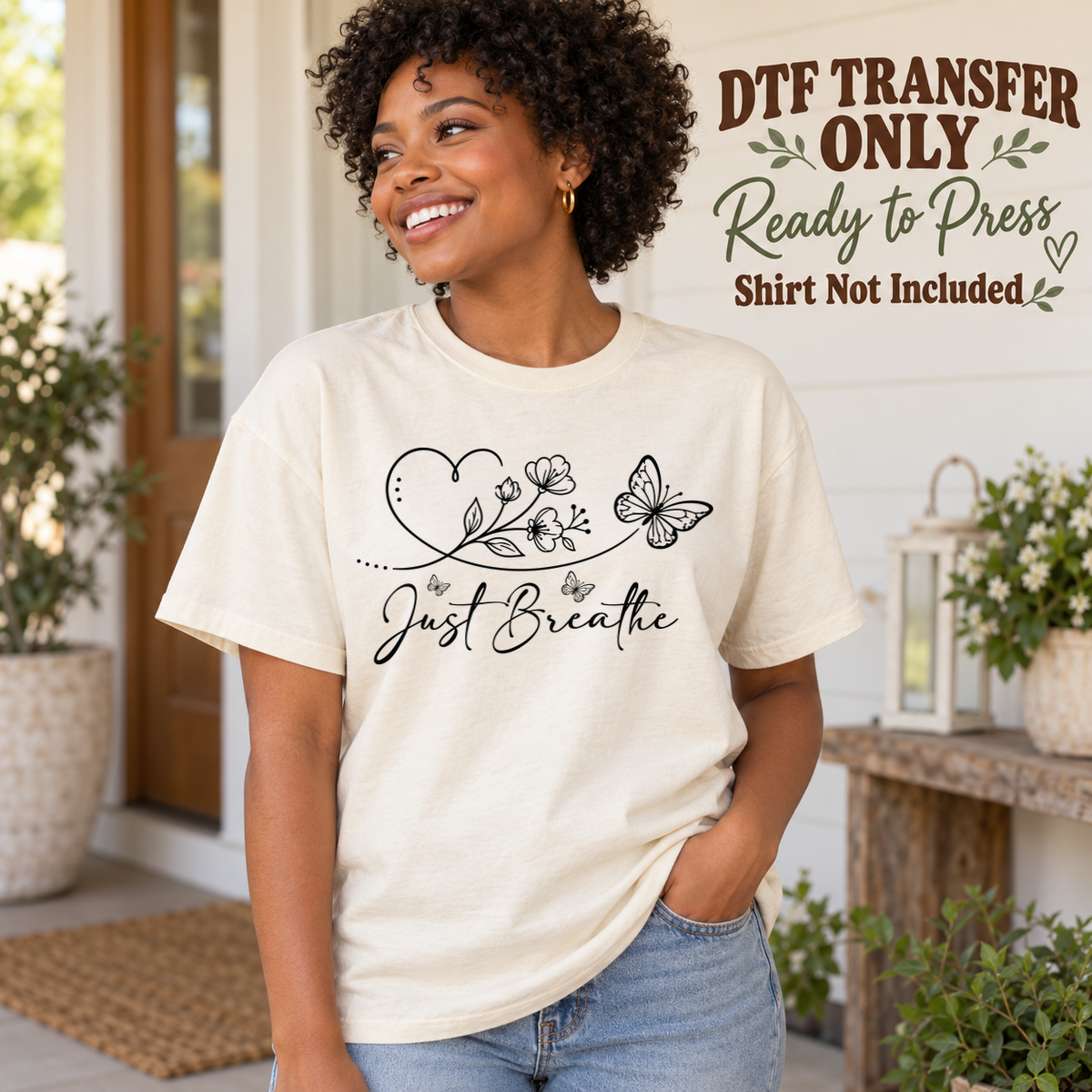 Black line-art heart, flowers and butterflies above Just Breathe script, shown on a cream shirt model mockup; physical DTF transfer only, shirt not included.