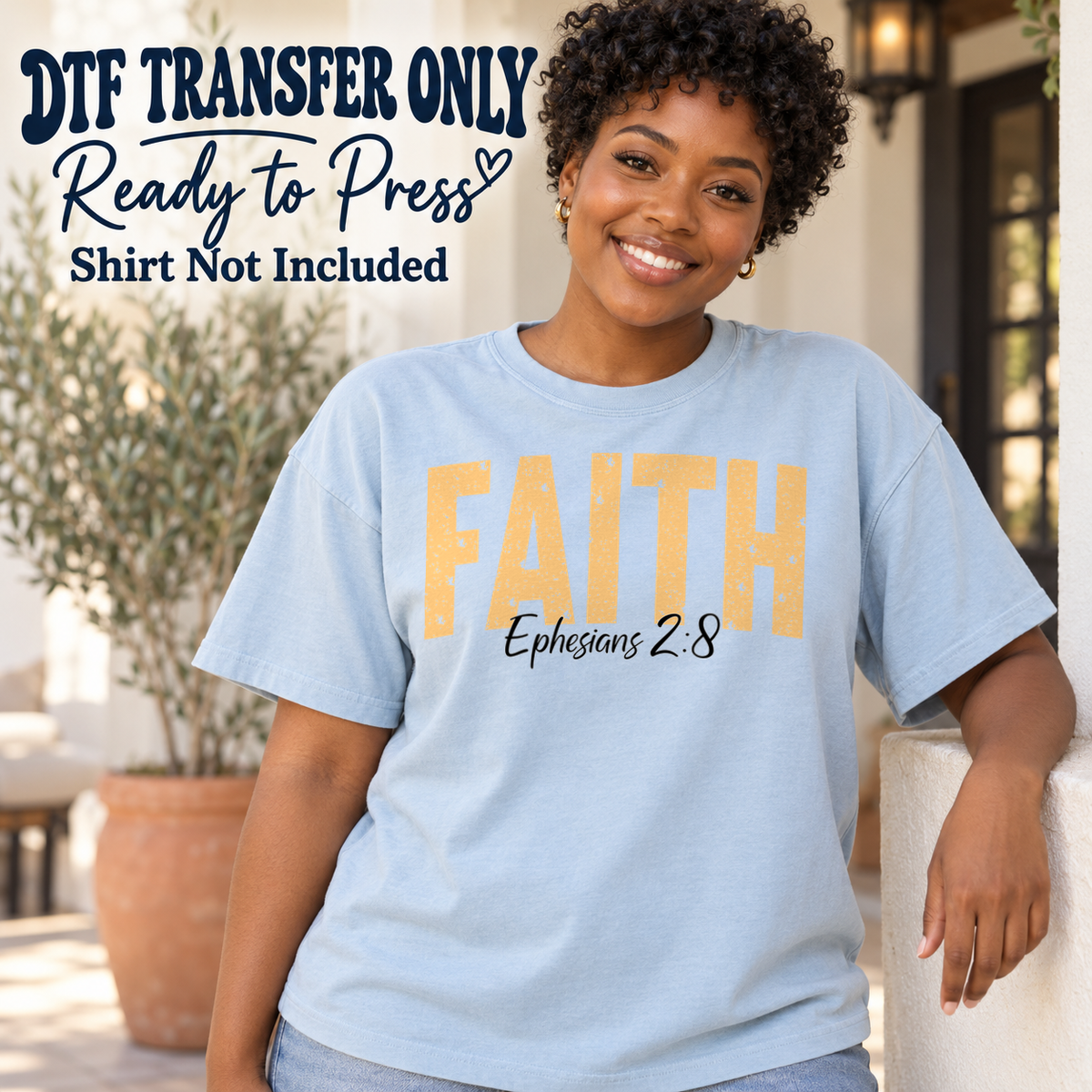 Warm yellow FAITH lettering above Ephesians 2:8 script, shown on a light blue shirt model mockup; physical DTF transfer only, shirt not included.