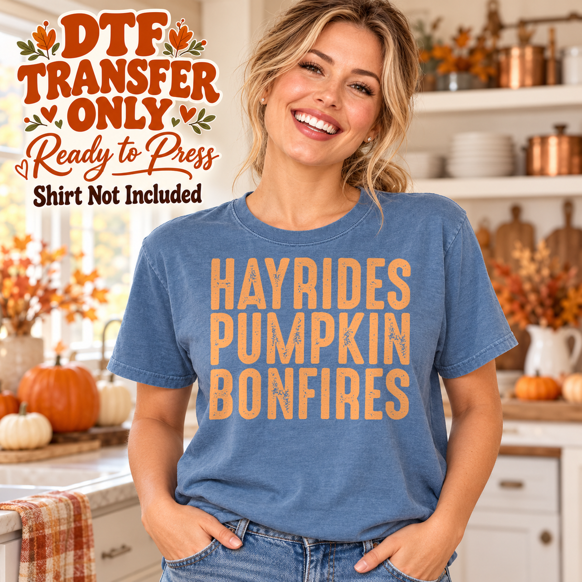Orange HAYRIDES PUMPKIN BONFIRES stacked lettering, shown on a blue shirt model mockup; physical DTF transfer only, shirt not included.