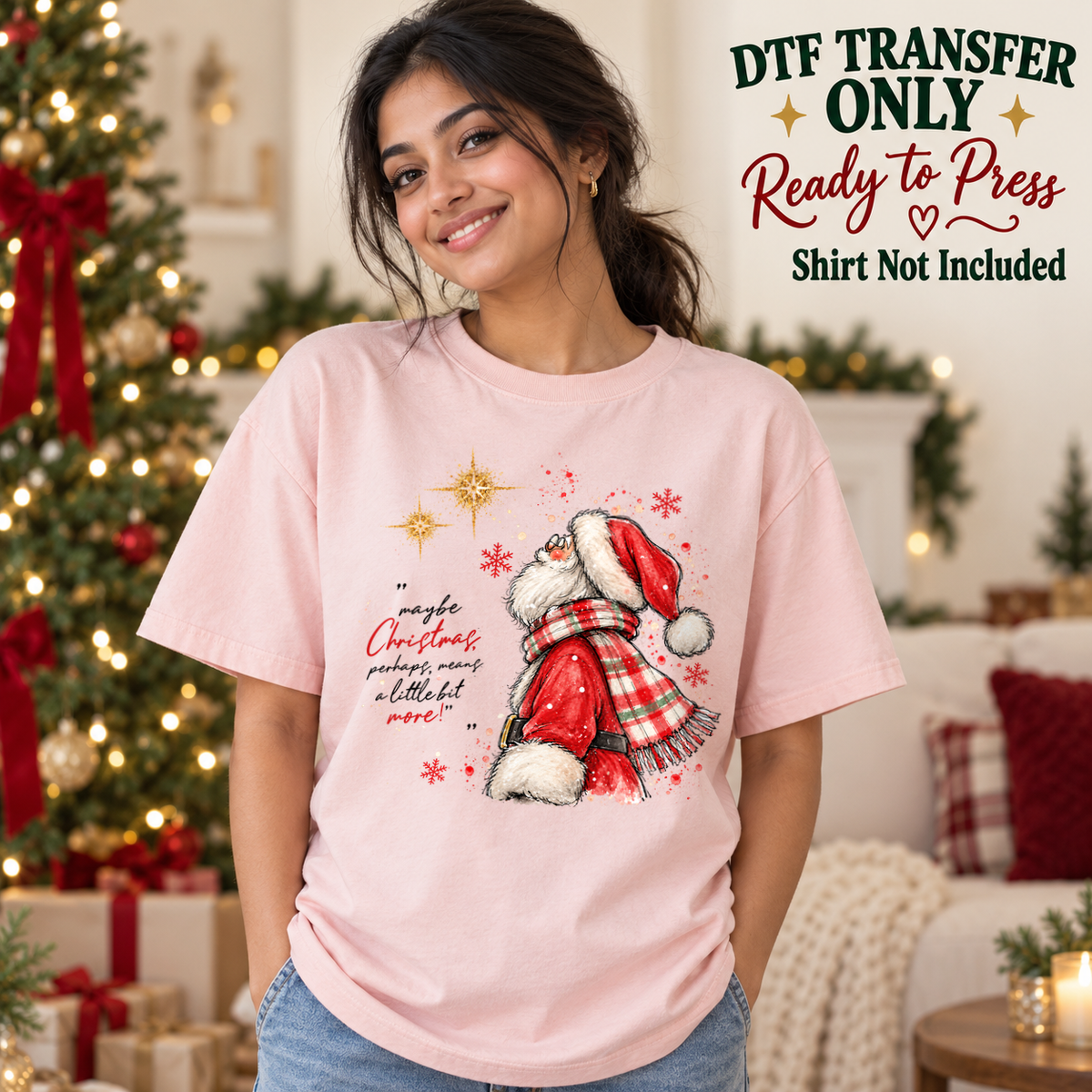 Santa in red winter clothes looking at a star beside a Christmas meaning quote, shown on a pink shirt model mockup; physical DTF transfer only, shirt not included.
