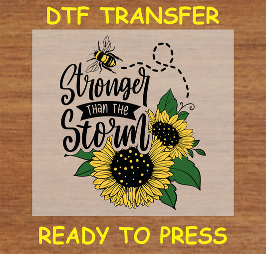 "DTF Transfer with 'Stronger Than the Storm' message, sunflower, and bee design for custom apparel"