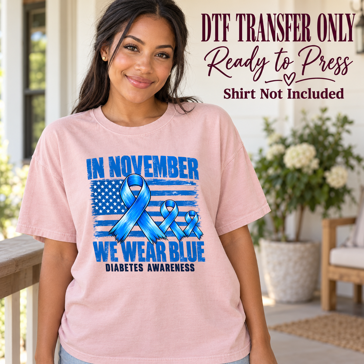 Model wearing a pink shirt showing In November We Wear Blue with a blue striped flag and awareness ribbons; DTF transfer only, shirt not included.