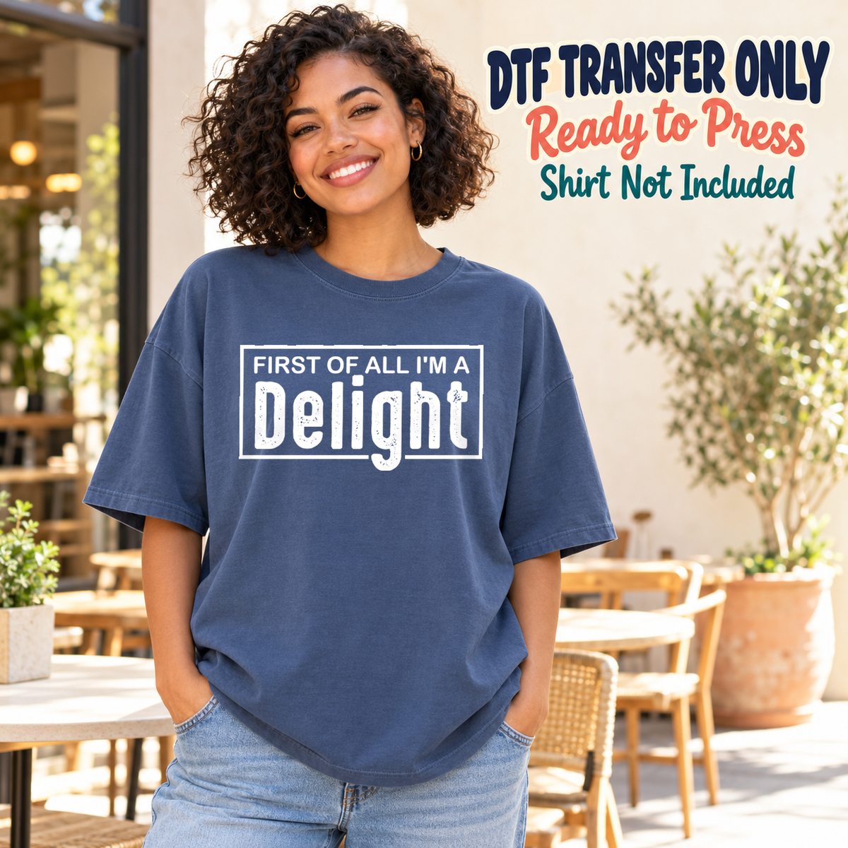 Model wearing a navy shirt showing First of All I’m a Delight in white framed lettering; DTF transfer only, shirt not included.