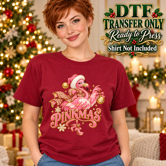 Model wearing a red shirt showing Pinkmas with a pink flamingo wearing a Santa hat and holiday ornaments; DTF transfer only, shirt not included.