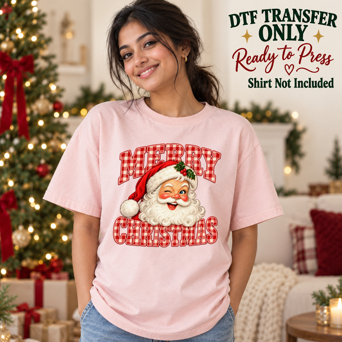 Model wearing a pink shirt with merry christmas red gingham text with santa face; DTF transfer only, shirt not included.