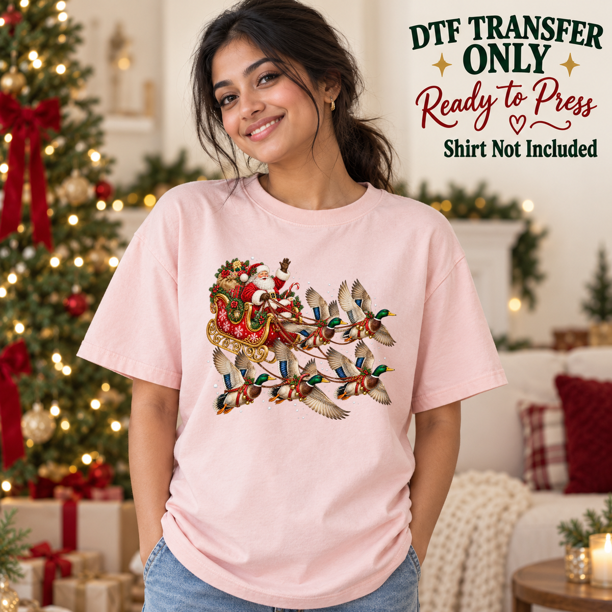 Model wearing a pink shirt with ducks pulling santa sleigh with gifts; DTF transfer only, shirt not included.