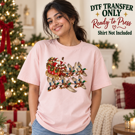 Model wearing a pink shirt with ducks pulling santa sleigh with gifts; DTF transfer only, shirt not included.