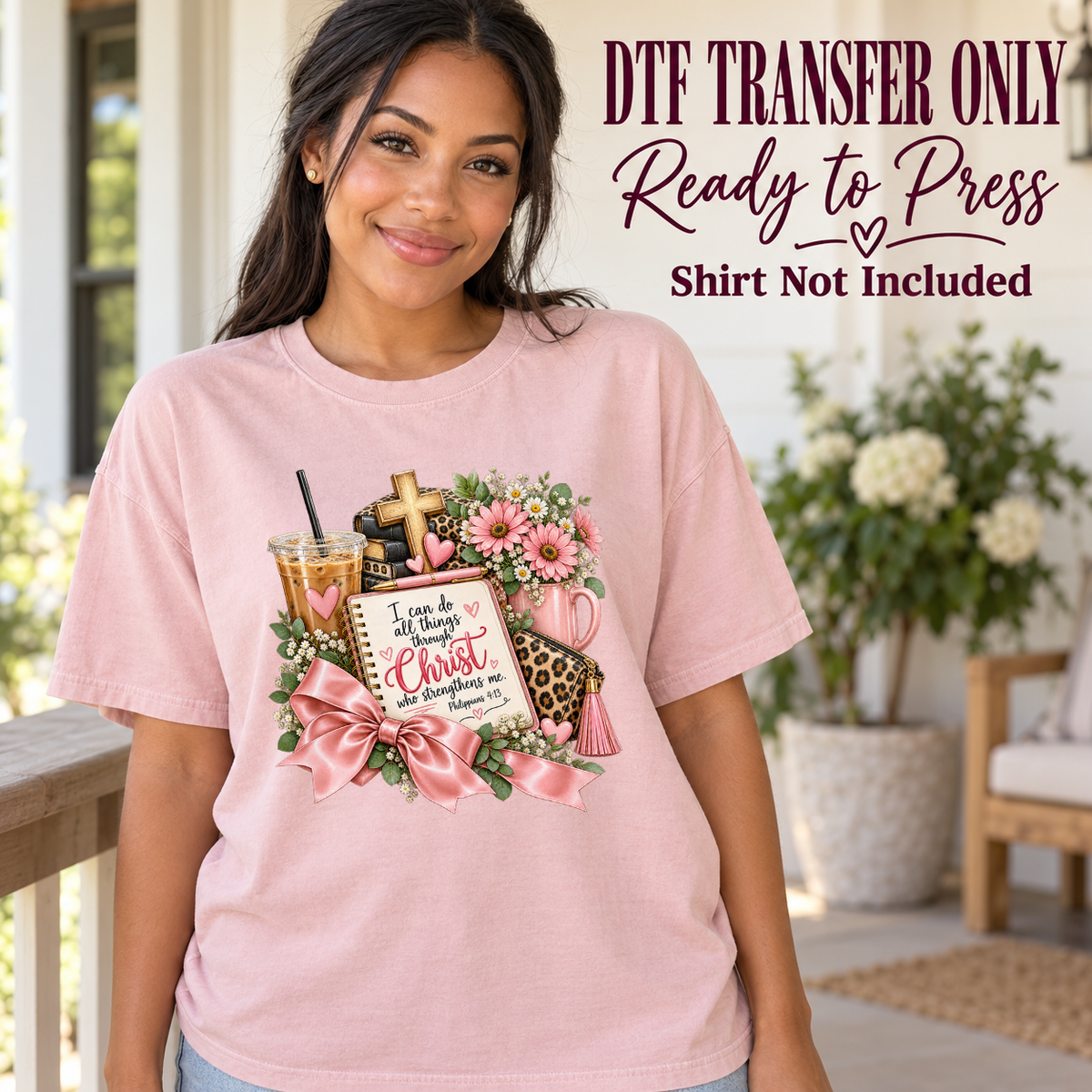 Model wearing a pink shirt with philippians 4:13 journal coffee cross flowers and pink bow; DTF transfer only, shirt not included.