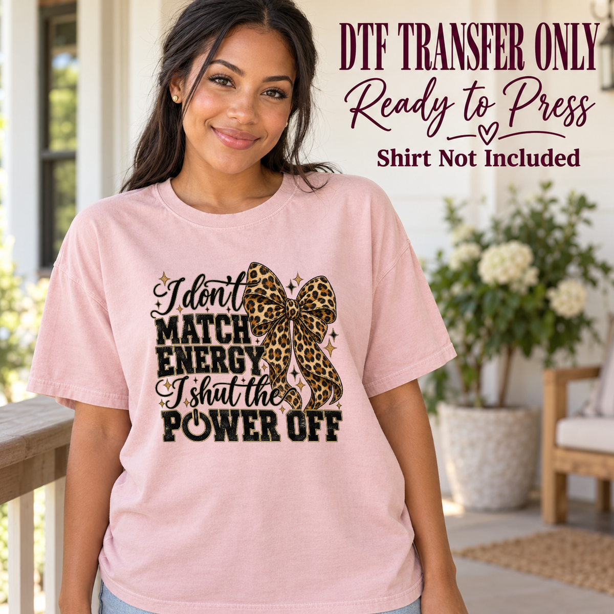 Model wearing a pink shirt with i don’t match energy i shut the power off with leopard bow; DTF transfer only, shirt not included.