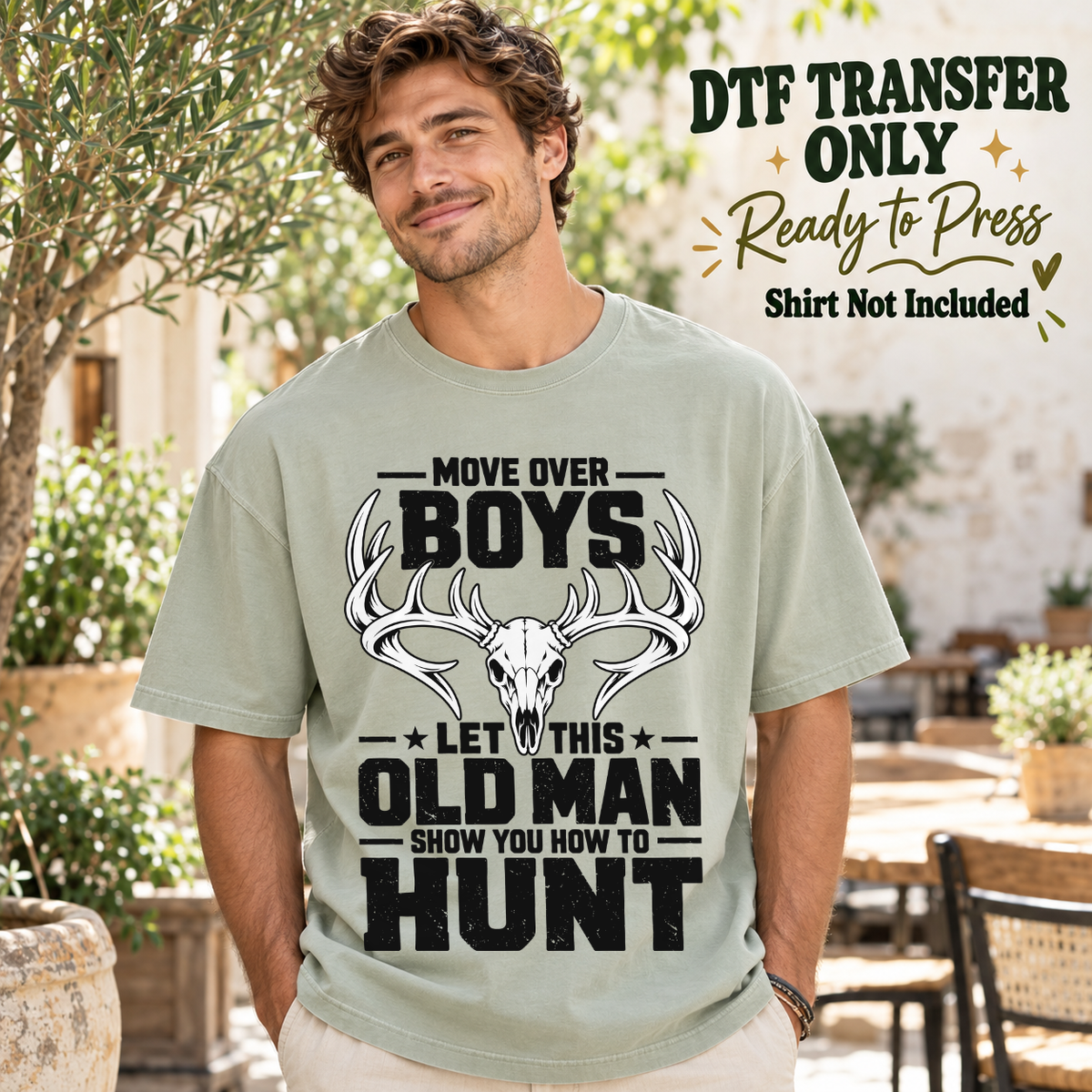 Move Over Boys Let This Old Man Show You How to Hunt black lettering and deer skull shown on a sage green shirt worn by a man; DTF transfer only, shirt not included.