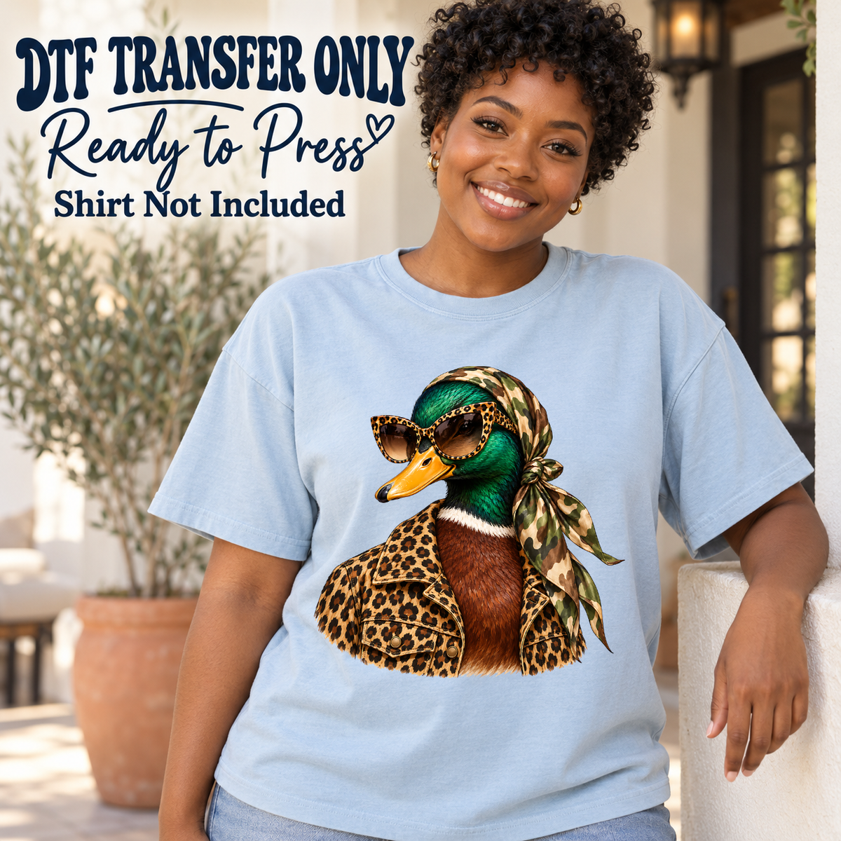 Duck wearing leopard sunglasses and a headscarf shown on a light blue shirt worn by a woman; DTF transfer only, shirt not included.
