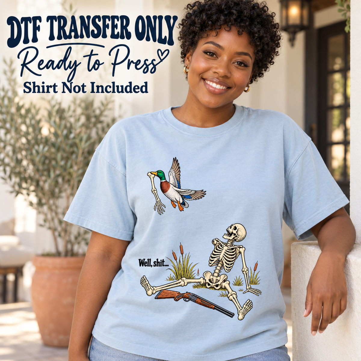 Well Shit duck hunting skeleton with dark text and a shotgun shown on a light blue shirt worn by a woman; DTF transfer only, shirt not included.