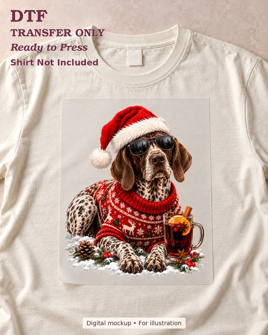 Christmas dog wearing sunglasses, a Santa hat and red sweater beside a winter drink, shown as a DTF sheet on a cream shirt.