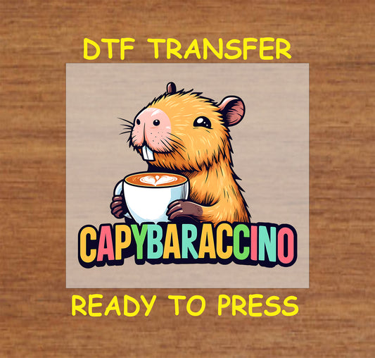 Capybaraccino DTF transfer featuring a capybara holding a cup of cappuccino with colorful text beneath.