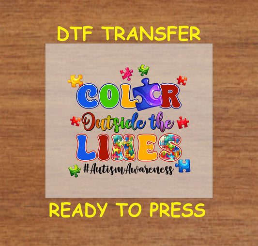 "Color Outside the Lines" Autism Awareness DTF transfer with colorful puzzle pieces and bold, vibrant text design.