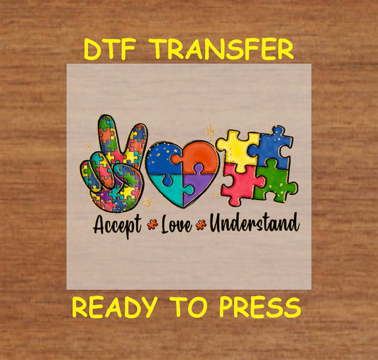 Colorful puzzle-piece design with peace sign, heart, and autism awareness message, ready-to-press DTF transfer.
