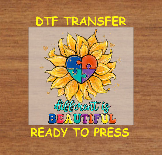 Sunflower with a colorful puzzle heart and "Different is Beautiful" text, autism awareness DTF transfer ready to press.