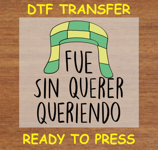DTF transfer design featuring a green and yellow hat with the text 'Fue Sin Querer Queriendo'.