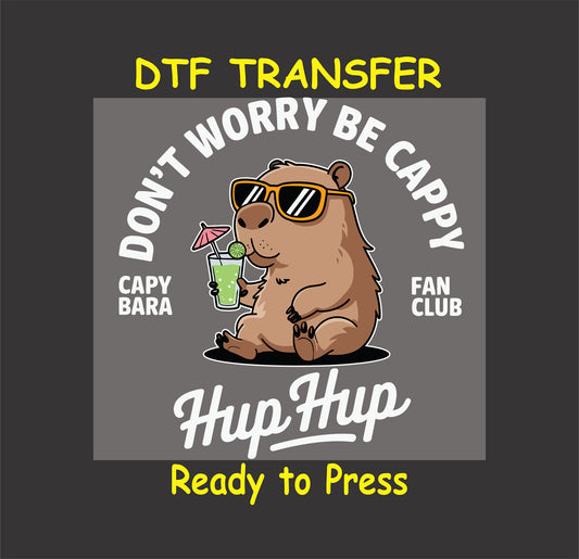 "Capybara wearing sunglasses and holding a drink with the phrase 'Don't Worry Be Cappy' for DTF transfer."