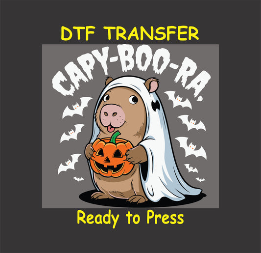 "Capybara in a ghost costume holding a pumpkin with bats in the background, Halloween DTF transfer."