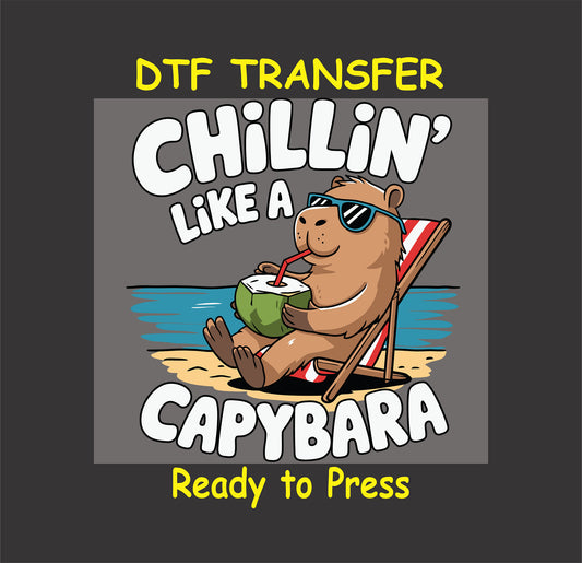 "Capybara lounging on a beach chair with sunglasses and a coconut drink, with the text 'Chillin' Like a Capybara' - DTF transfer for custom apparel."