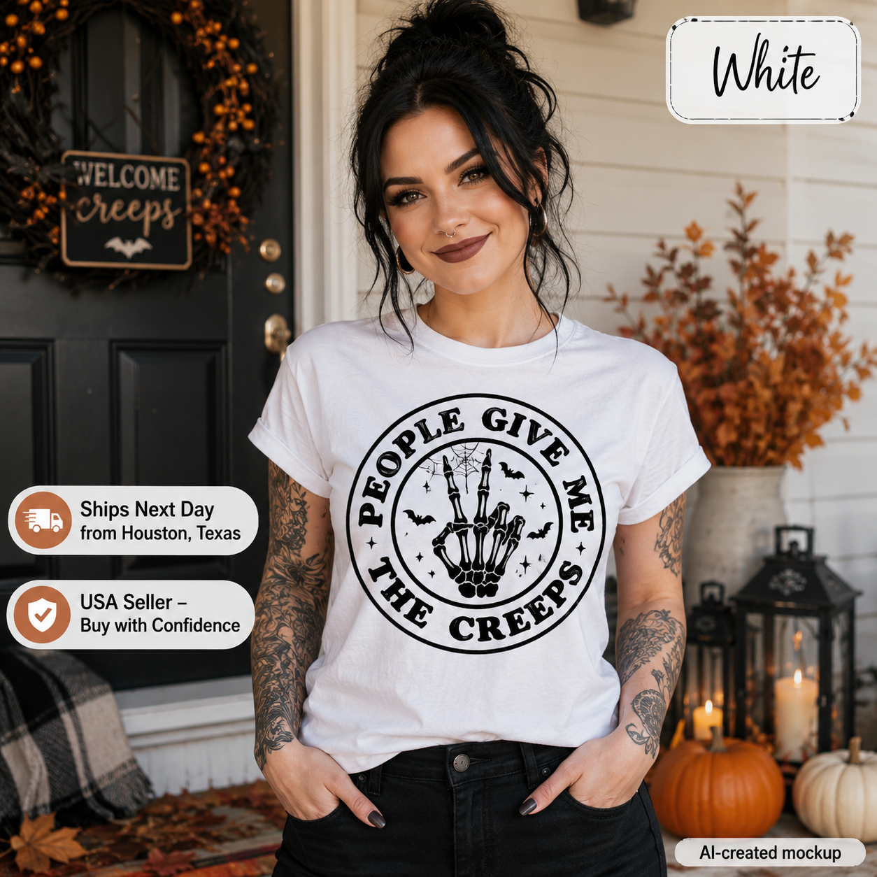 A woman wearing a white graphic t-shirt with a black circular design that reads 'PEOPLE GIVE ME THE CREEPS' around a skeleton hand holding a shotgun. The photo is set on a decorated front porch with pumpkins, lanterns, and autumn decorations.
