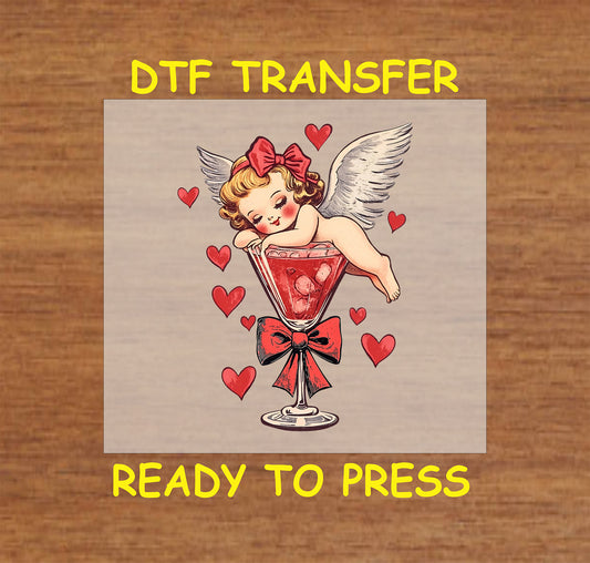 Vintage-style Cupid Valentine's Day DTF transfer with cherub in a cocktail glass surrounded by hearts and a red bow.