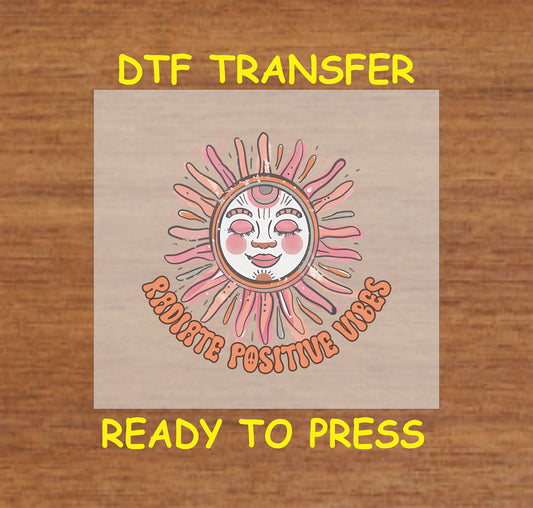 "DTF transfer featuring a smiling sun and the phrase 'Radiate Positive Vibes' in bold, retro-style lettering."